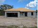 Unfinished concrete block home with exposed wood roofing being built in a sunny, undeveloped neighborhood at 13322 Sw 85 Cir, Ocala, FL 34473