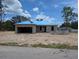 Unfinished concrete block home with blue roofing being built in a sunny, undeveloped neighborhood at 13322 Sw 85 Cir, Ocala, FL 34473