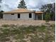Angled side view of unfinished concrete block home with exposed wood roofing in undeveloped neighborhood at 13322 Sw 85 Cir, Ocala, FL 34473