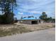 Unfinished concrete block home with blue roofing being built in a sunny, undeveloped neighborhood at 13322 Sw 85 Cir, Ocala, FL 34473