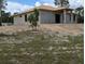 Angled side view of unfinished concrete block home with exposed wood roofing in undeveloped neighborhood at 13322 Sw 85 Cir, Ocala, FL 34473