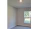 Bedroom with neutral walls and carpet, showing natural light from a window at 13585 Sw 51St Ln, Ocala, FL 34481