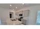 Kitchen with granite countertops, stainless steel appliances, and gray cabinetry at 13585 Sw 51St Ln, Ocala, FL 34481