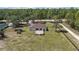Aerial view of the home showing the spacious fenced yard and surrounding wooded area at 13741 Sw 73Rd St, Ocala, FL 34481