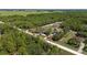 Aerial perspective of a property bordered by lush trees and expansive green spaces at 13741 Sw 73Rd St, Ocala, FL 34481