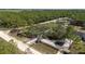 Aerial shot of a property featuring an expansive yard, mature trees, and long paved drive at 13741 Sw 73Rd St, Ocala, FL 34481