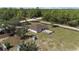Aerial view of the home on a large lot, featuring a fenced-in backyard and wooded surroundings at 13741 Sw 73Rd St, Ocala, FL 34481