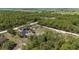 High-angle aerial view capturing homes nestled amongst dense woodland and green fields at 13741 Sw 73Rd St, Ocala, FL 34481