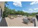 Furnished back deck with dining and lounge seating offers ample room for entertaining at 13741 Sw 73Rd St, Ocala, FL 34481