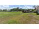 Large grassy backyard area featuring a spacious deck, perfect for outdoor gatherings at 13741 Sw 73Rd St, Ocala, FL 34481