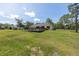 Spacious backyard with a deck, lush green grass, and partial fencing at 13741 Sw 73Rd St, Ocala, FL 34481
