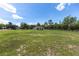 Vast backyard features green lawn and mature trees, complemented by white and dark fencing at 13741 Sw 73Rd St, Ocala, FL 34481