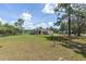 Broad exterior view of a single-story home with a large yard and privacy-assuring mature trees at 13741 Sw 73Rd St, Ocala, FL 34481