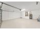 Spacious garage with sealed floor, overhead lighting, and utility access at 13741 Sw 73Rd St, Ocala, FL 34481