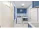 Charming laundry room with blue cabinetry, new machines, and decorative floor tiles at 13741 Sw 73Rd St, Ocala, FL 34481