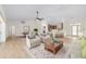 Living room showcases an open floor plan with hardwood floors, chairs, sofa, and dining space at 13741 Sw 73Rd St, Ocala, FL 34481