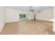 Open floor plan with hardwood floors connecting the kitchen, living room, and patio at 13741 Sw 73Rd St, Ocala, FL 34481