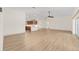Spacious living room with hardwood floors and open floor plan to kitchen and patio at 13741 Sw 73Rd St, Ocala, FL 34481