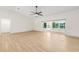 Spacious living room with an open floor plan, hardwood floors, and a sliding door leading to the patio at 13741 Sw 73Rd St, Ocala, FL 34481