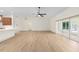 Spacious living room with hardwood floors, flowing into kitchen and patio area at 13741 Sw 73Rd St, Ocala, FL 34481