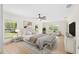 Staged main bedroom with sitting area, neutral color palette, and hardwood floors at 13741 Sw 73Rd St, Ocala, FL 34481