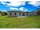 New construction home with a spacious backyard featuring a well-maintained lawn and patio at 13780 Sw 42Nd Court Rd, Ocala, FL 34473