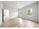 Bright bedroom with multiple windows and wood-look floors at 13780 Sw 42Nd Court Rd, Ocala, FL 34473