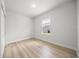 Cozy bedroom featuring wood-look floors and a window at 13780 Sw 42Nd Court Rd, Ocala, FL 34473