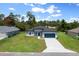 Aerial view of a charming single-Gathering home featuring a well-manicured lawn and attached two car garage at 13780 Sw 42Nd Court Rd, Ocala, FL 34473