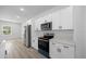Modern kitchen featuring stainless steel appliances, quartz countertops, and sleek white cabinetry at 13780 Sw 42Nd Court Rd, Ocala, FL 34473