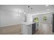 Modern kitchen featuring stainless steel appliances and sleek, white cabinetry with a center island at 13780 Sw 42Nd Court Rd, Ocala, FL 34473