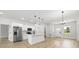 Open-concept kitchen with stainless steel appliances and bright living area with lots of natural light at 13780 Sw 42Nd Court Rd, Ocala, FL 34473