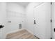 Clean laundry room with modern wire shelving, gray plank floors, and white walls and door at 13780 Sw 42Nd Court Rd, Ocala, FL 34473