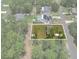 Aerial view of a property showcasing the house, lawn, and surrounding wooded area at 15138 Sw 50Th Avenue Rd, Ocala, FL 34473