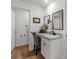 Bathroom featuring a vanity with sink, mirror, gray chair, wood-look flooring, and painted white walls at 15138 Sw 50Th Avenue Rd, Ocala, FL 34473