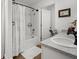 Bright bathroom featuring a shower-tub combo, a gray vanity, and framed decoration at 15138 Sw 50Th Avenue Rd, Ocala, FL 34473