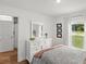 Bedroom features a large window, a mirror, and a chest of drawers with decorations at 15138 Sw 50Th Avenue Rd, Ocala, FL 34473