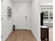 Bright and airy foyer with wood-look flooring and a view into the living area at 15138 Sw 50Th Avenue Rd, Ocala, FL 34473