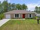 Well-maintained single-story home with a lush front lawn and attached garage at 15138 Sw 50Th Avenue Rd, Ocala, FL 34473