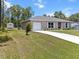 Landscaped front yard of a single-story home with an attached garage at 15138 Sw 50Th Avenue Rd, Ocala, FL 34473