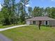 Beautiful single-story home with a spacious lawn and a long driveway at 15138 Sw 50Th Avenue Rd, Ocala, FL 34473
