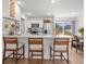 Kitchen island with breakfast bar seating, stainless steel appliances, and abundant natural light at 15138 Sw 50Th Avenue Rd, Ocala, FL 34473
