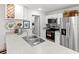 Bright kitchen featuring stainless steel appliances, granite countertops, and a stylish wine rack at 15138 Sw 50Th Avenue Rd, Ocala, FL 34473