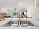 Kitchen sink with stainless steel faucet overlooking the living area at 15138 Sw 50Th Avenue Rd, Ocala, FL 34473
