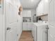 Well-lit laundry room with washer, dryer, and ample storage space at 15138 Sw 50Th Avenue Rd, Ocala, FL 34473