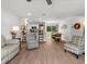 Open-concept living area with a view of the kitchen, dining area, and sliding glass doors at 15138 Sw 50Th Avenue Rd, Ocala, FL 34473