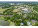 Overhead view showcasing the lush neighborhood surroundings with a church, sports field, and residential area at 1630 Se 29Th Ter, Ocala, FL 34471