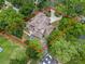Expansive aerial view of home with a sparkling screened-in pool, surrounded by lush greenery and mature trees at 1630 Se 29Th Ter, Ocala, FL 34471
