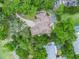 Aerial view of home with circular driveway, pool and lush landscaping at 1630 Se 29Th Ter, Ocala, FL 34471
