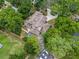 Aerial view of property featuring a pool, large backyard, mature trees and a spacious driveway at 1630 Se 29Th Ter, Ocala, FL 34471